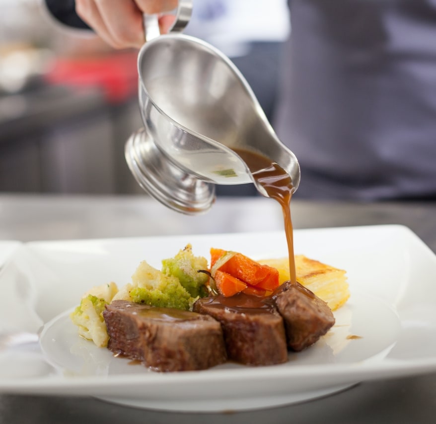 pouring sauce on steaks