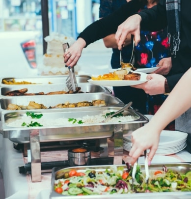 people taking food from chafing dishes